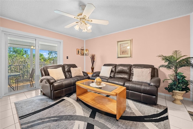 living room with ceiling fan, light tile patterned flooring, a textured ceiling, and ornamental molding