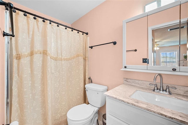 bathroom featuring vanity, toilet, and ceiling fan