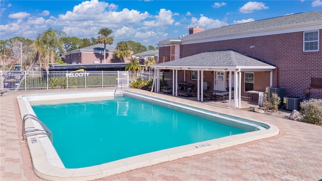 view of swimming pool with a patio and central AC unit