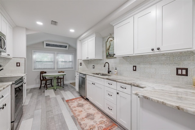 kitchen featuring sink, white cabinets, light hardwood / wood-style floors, and appliances with stainless steel finishes