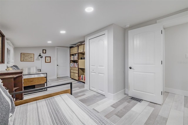 bedroom featuring a closet and light wood-type flooring