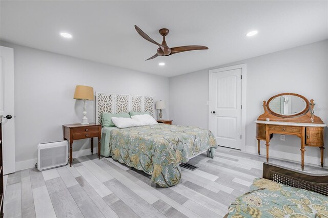 bedroom with ceiling fan and light hardwood / wood-style floors