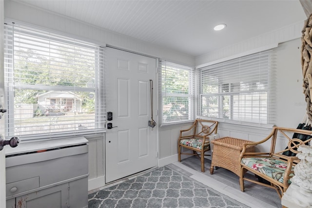 foyer entrance featuring wood walls