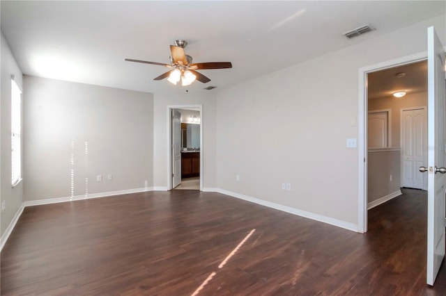 unfurnished room with ceiling fan and dark hardwood / wood-style flooring