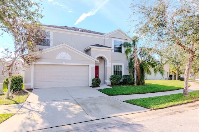 view of front of home with a front yard and a garage