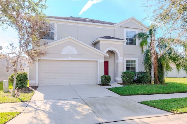 view of front of property featuring a garage and a front yard