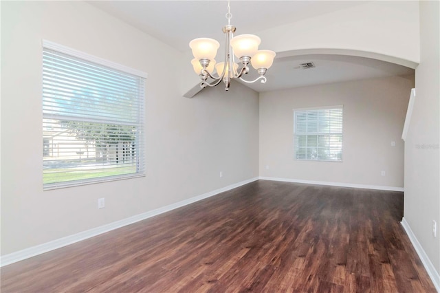 unfurnished room with dark wood-type flooring and a chandelier