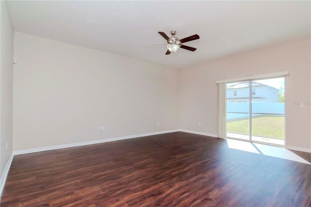 unfurnished room featuring dark hardwood / wood-style floors and ceiling fan