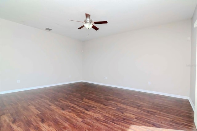 spare room with ceiling fan and dark wood-type flooring