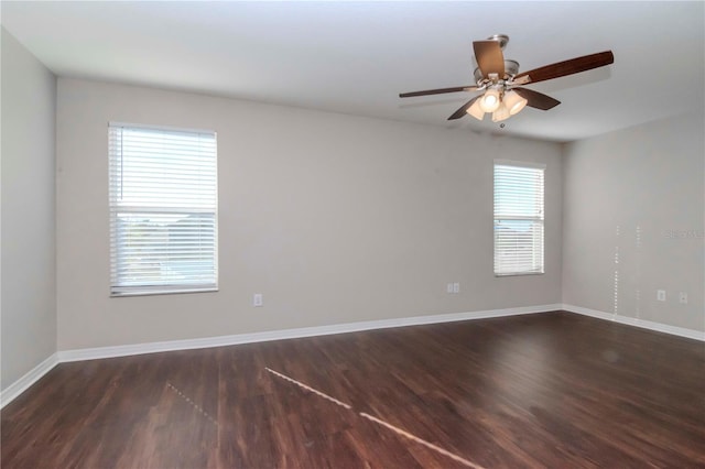 empty room featuring ceiling fan and dark wood-type flooring