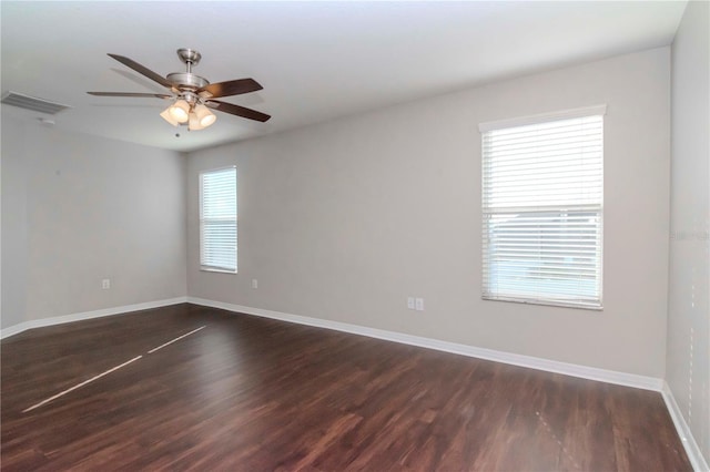 unfurnished room featuring ceiling fan and dark wood-type flooring