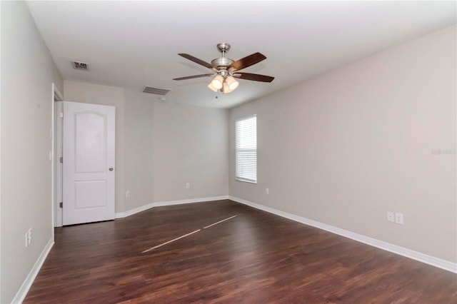 spare room featuring ceiling fan and dark hardwood / wood-style flooring