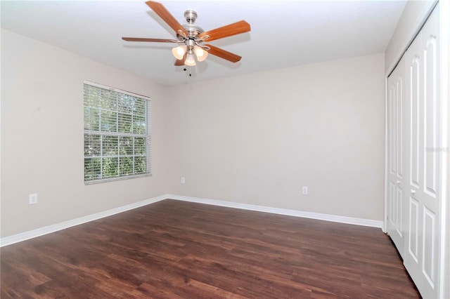 unfurnished bedroom featuring ceiling fan, dark hardwood / wood-style floors, and a closet