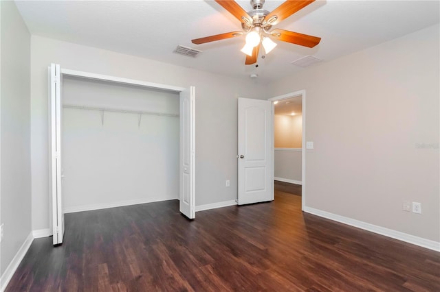 unfurnished bedroom with ceiling fan, a closet, and dark hardwood / wood-style floors