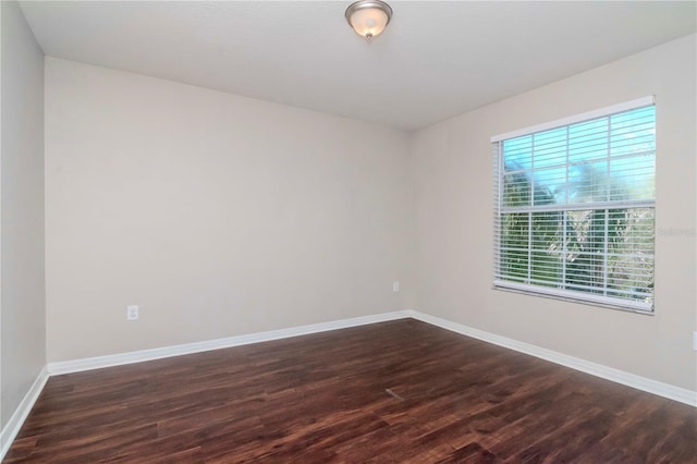 spare room with dark wood-type flooring