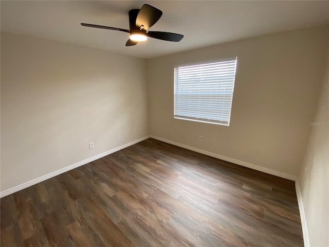 unfurnished room featuring ceiling fan and dark wood-type flooring