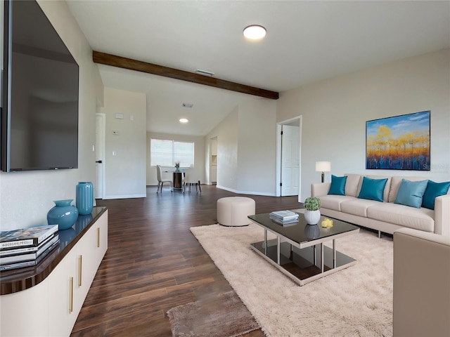 living room featuring beamed ceiling and dark hardwood / wood-style flooring