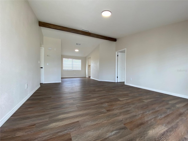 spare room featuring beam ceiling and dark hardwood / wood-style floors