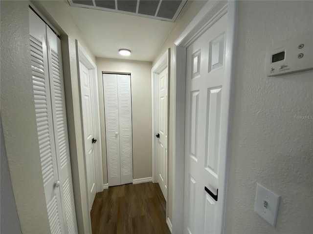 hallway with dark wood-type flooring