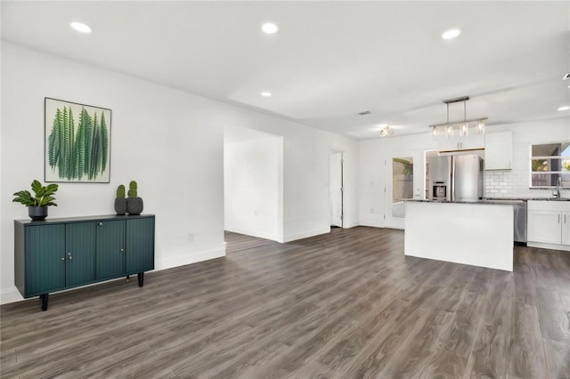 unfurnished living room with sink and dark hardwood / wood-style floors