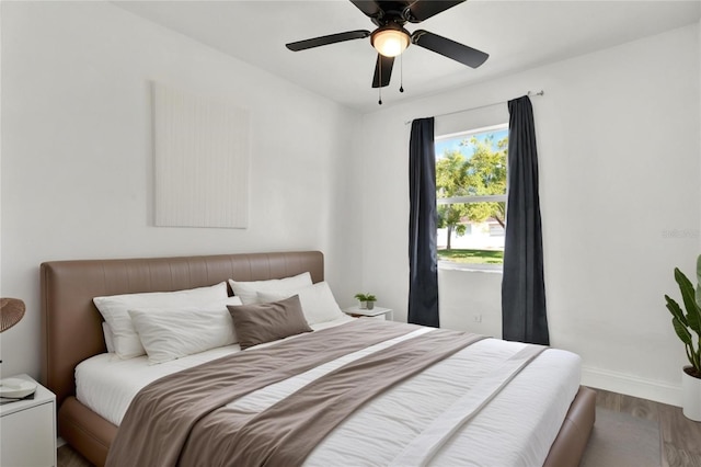 bedroom with ceiling fan and hardwood / wood-style floors