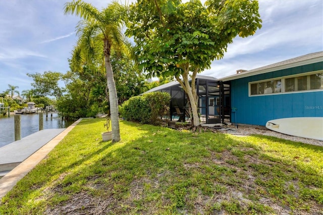 view of yard featuring a lanai and a water view