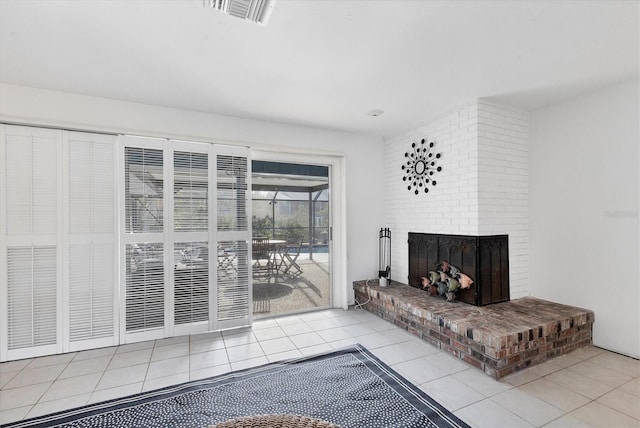 living room with a fireplace and light tile patterned flooring