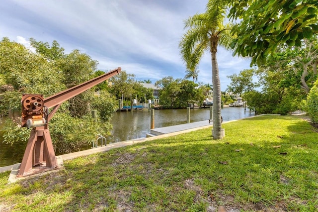 view of yard featuring a boat dock and a water view