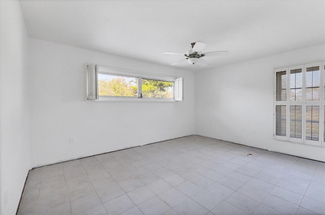 unfurnished room featuring plenty of natural light and ceiling fan