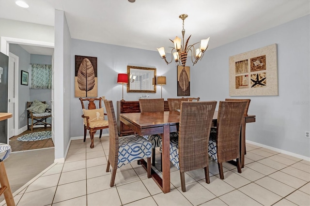 tiled dining space featuring a notable chandelier