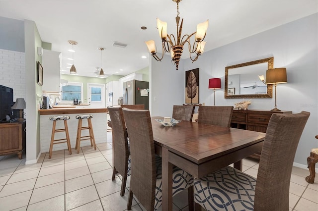 dining room featuring light tile patterned floors and a chandelier