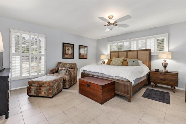 bedroom with multiple windows, light tile patterned floors, and ceiling fan