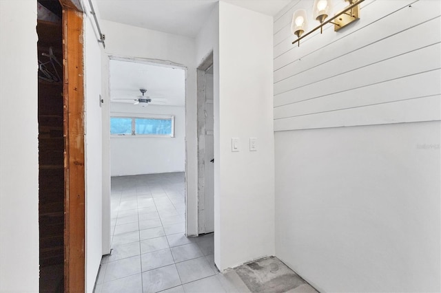 hall featuring light tile patterned flooring