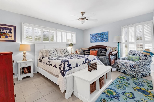 tiled bedroom featuring ceiling fan