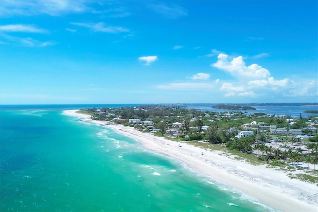 birds eye view of property with a beach view and a water view