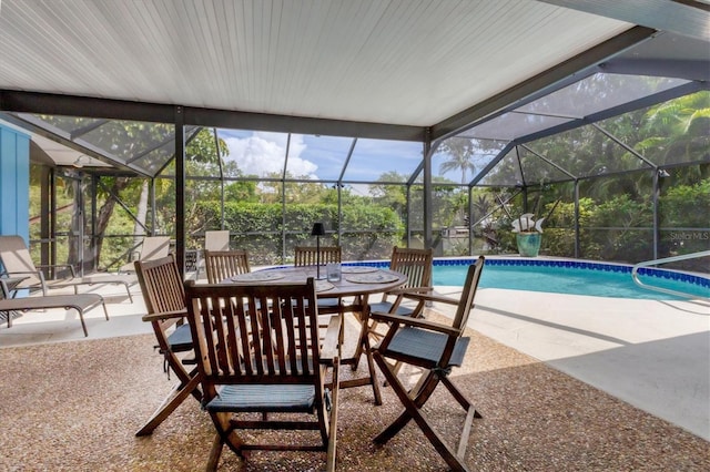 view of pool featuring glass enclosure and a patio area