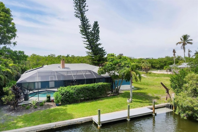 dock area featuring a lawn, glass enclosure, and a water view