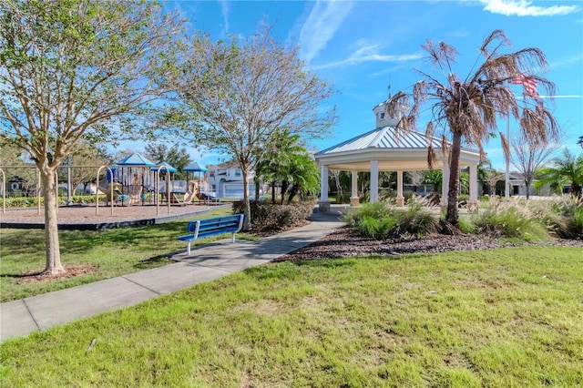 view of property's community with a playground and a lawn