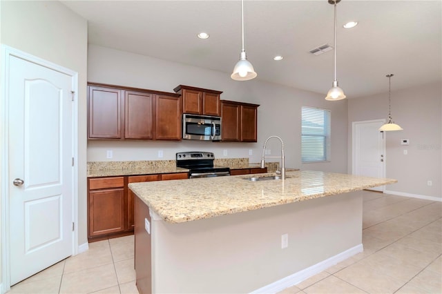 kitchen featuring a kitchen island with sink, sink, light tile patterned floors, appliances with stainless steel finishes, and decorative light fixtures