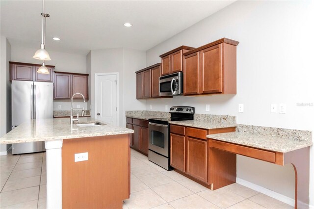 kitchen with appliances with stainless steel finishes, sink, a center island with sink, hanging light fixtures, and light tile patterned flooring