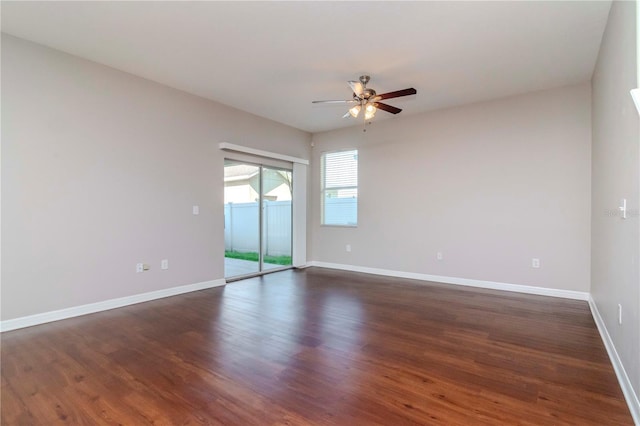 empty room with ceiling fan and dark hardwood / wood-style floors