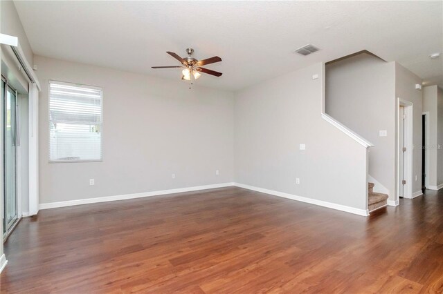 unfurnished room with ceiling fan and dark hardwood / wood-style flooring