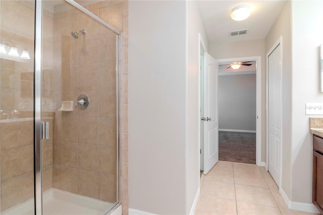 bathroom featuring tile patterned flooring, vanity, a shower with door, and ceiling fan