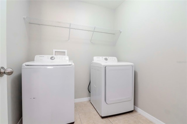 washroom featuring independent washer and dryer and light tile patterned floors