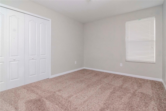 unfurnished bedroom featuring a closet and carpet