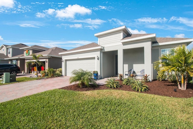 prairie-style house featuring a front yard and a garage