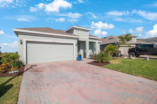 ranch-style house featuring a garage and a front lawn