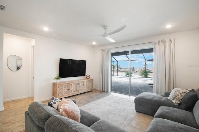 living room featuring ceiling fan and light hardwood / wood-style floors