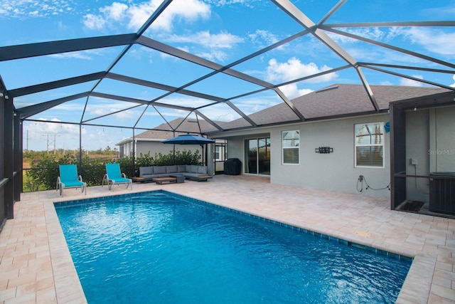 view of swimming pool featuring an outdoor living space, glass enclosure, cooling unit, and a patio area