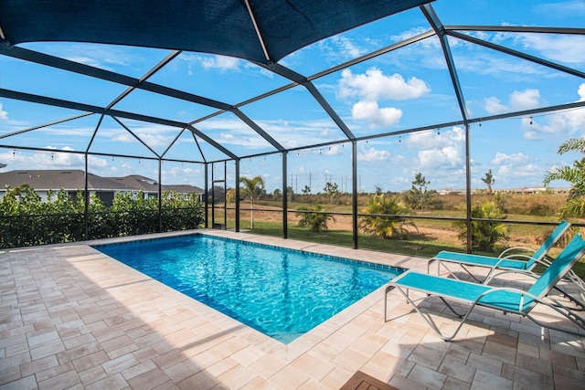 view of swimming pool with a patio and a lanai